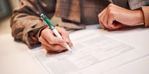 Time to sign deal contract. Businesswoman is fulfilling and signing contract